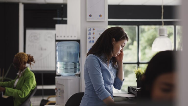 side-view-young-woman-using-mobile-phone-office
