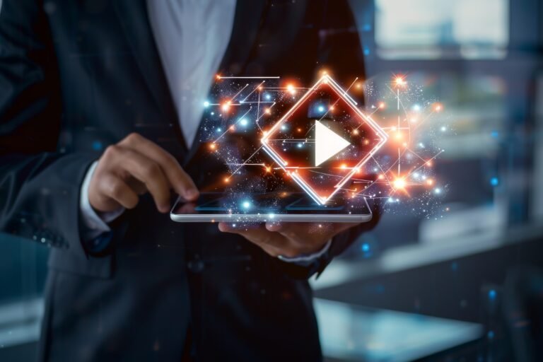 Unrecognizable man in a suit holding a tablet from which a digital screen with a play symbol is emerging