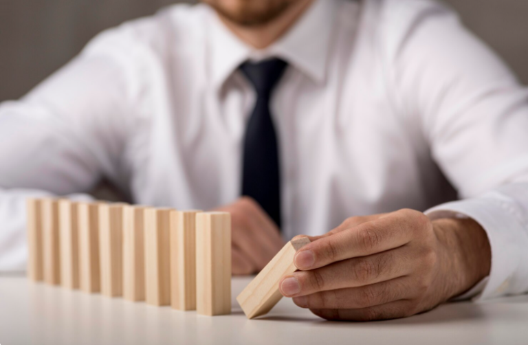 Defocused businessman in suit and tie with dominoes